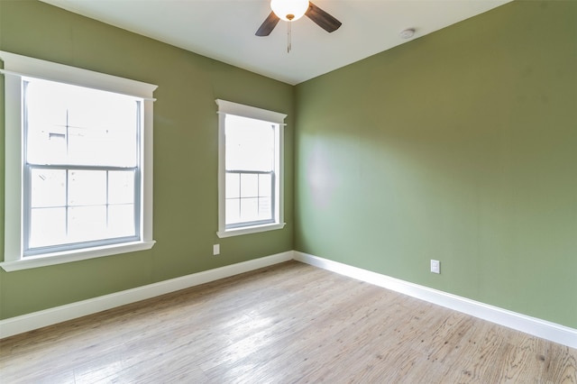 spare room featuring light hardwood / wood-style flooring and ceiling fan