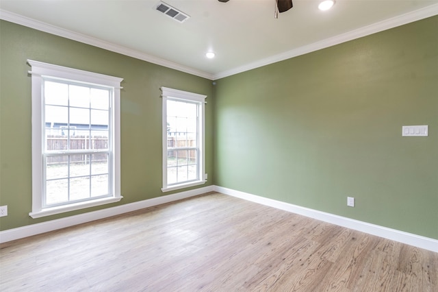 spare room featuring ornamental molding, light hardwood / wood-style floors, and ceiling fan