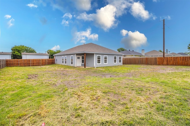 rear view of property featuring a yard