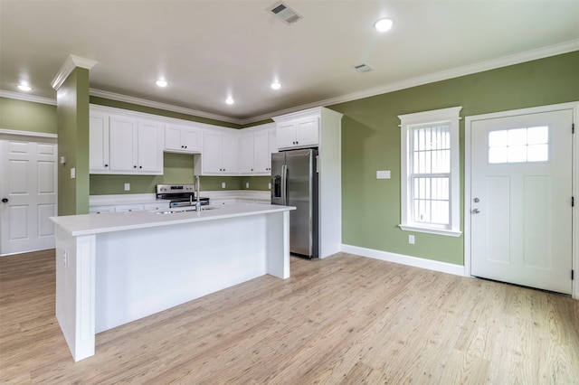 kitchen featuring white cabinets, crown molding, a center island with sink, stainless steel fridge with ice dispenser, and light hardwood / wood-style floors