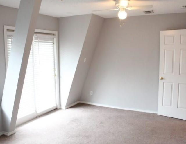 carpeted empty room featuring ceiling fan