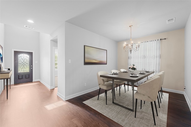 dining space with an inviting chandelier and wood-type flooring