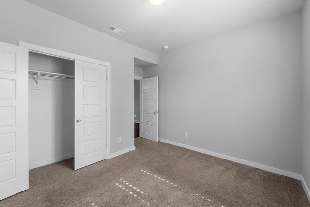 unfurnished bedroom featuring a closet and carpet floors