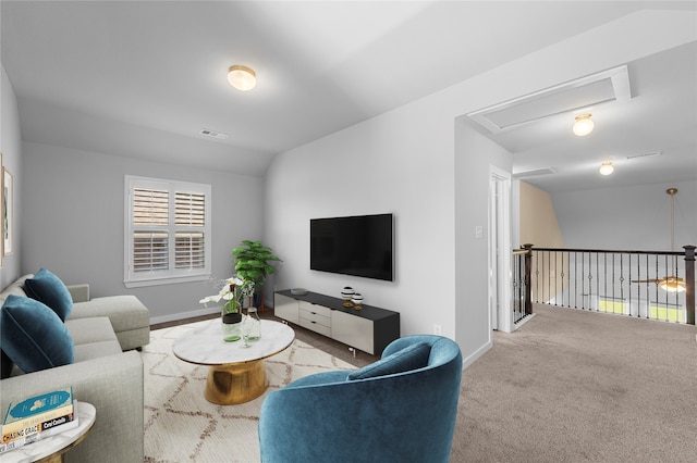 carpeted living room with lofted ceiling