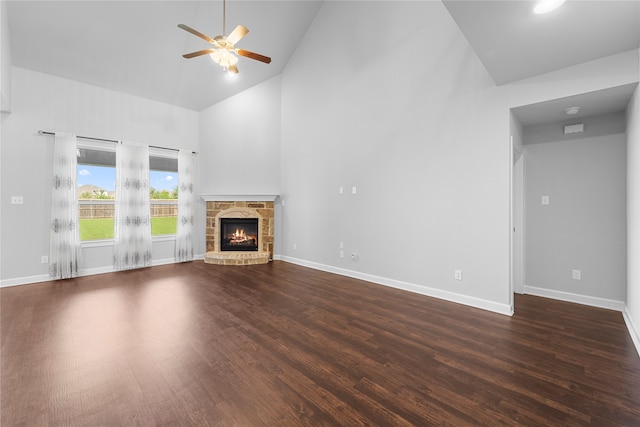 unfurnished living room with high vaulted ceiling, wood-type flooring, ceiling fan, and a fireplace