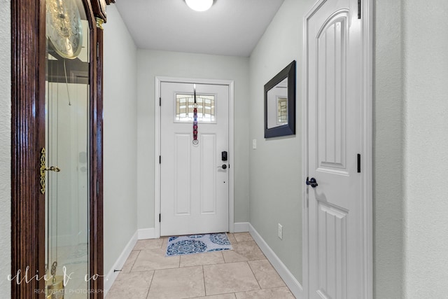 foyer entrance with light tile floors