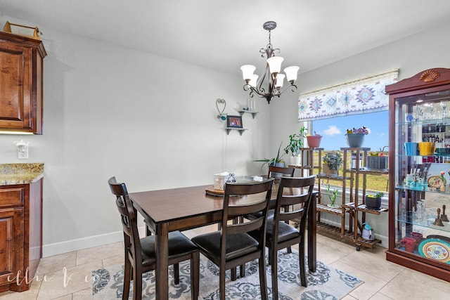 dining room featuring a notable chandelier and light tile flooring