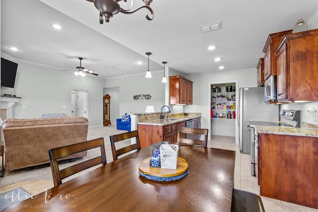 tiled dining room featuring ceiling fan and sink