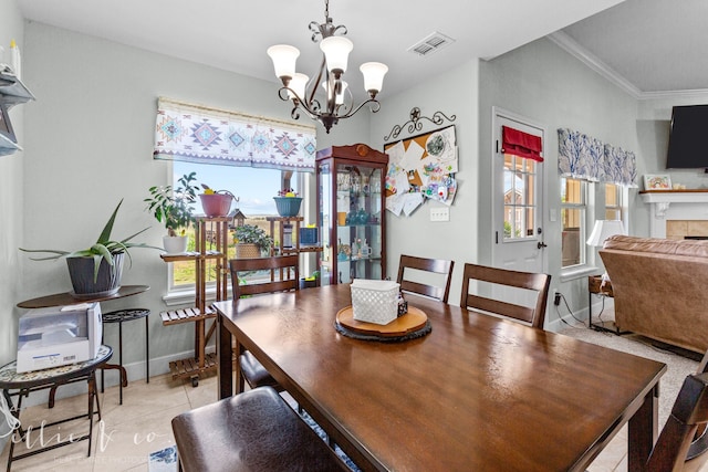 dining space featuring plenty of natural light, crown molding, an inviting chandelier, and light tile floors