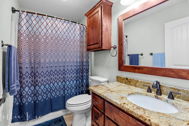 bathroom with toilet, tile floors, and vanity