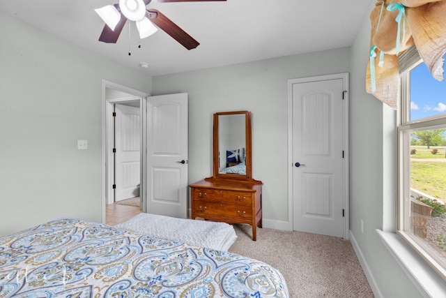 bedroom with light colored carpet and ceiling fan