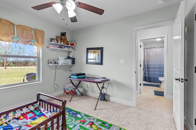 carpeted bedroom with connected bathroom and ceiling fan