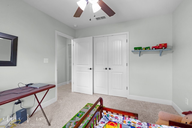 carpeted bedroom with a closet and ceiling fan