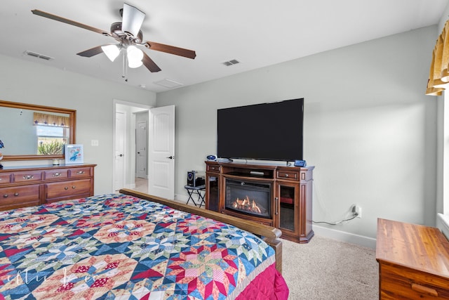 bedroom with ceiling fan and light carpet