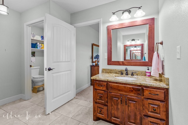 bathroom with vanity, tile floors, and toilet