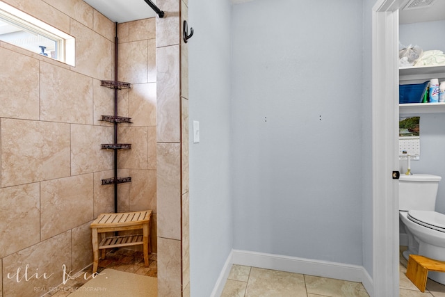 bathroom with toilet and tile flooring