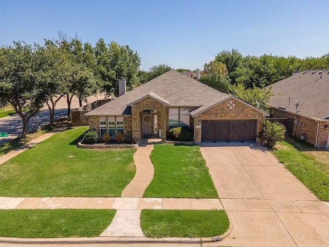 view of front of house with a garage and a front lawn