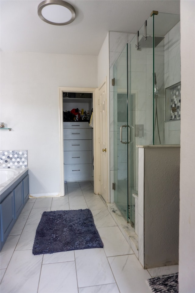 bathroom featuring shower with separate bathtub and tile floors