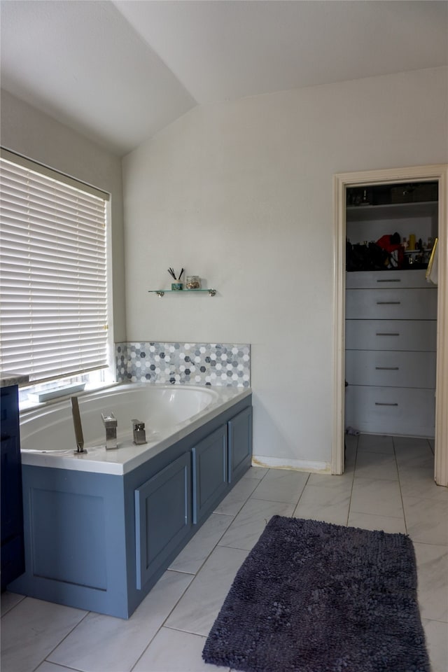 bathroom featuring a washtub and tile floors