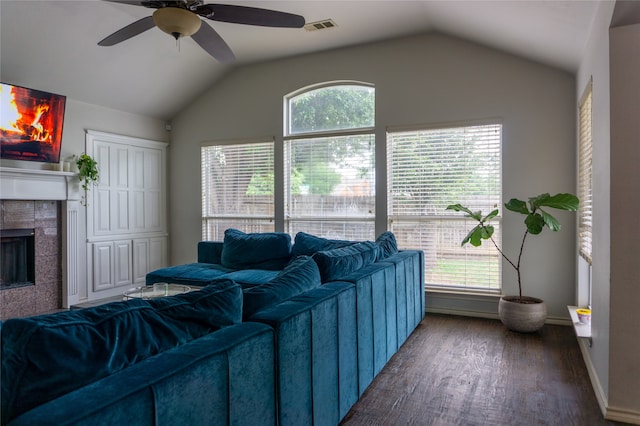 living room with a wealth of natural light, vaulted ceiling, and hardwood / wood-style floors