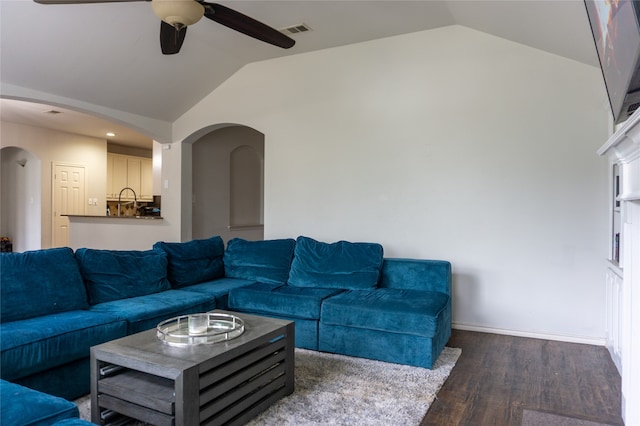 living room featuring dark hardwood / wood-style floors, ceiling fan, and lofted ceiling