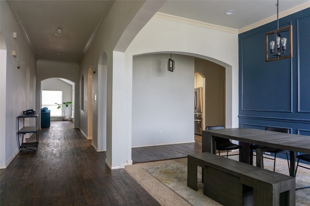 hallway with ornamental molding and dark hardwood / wood-style floors