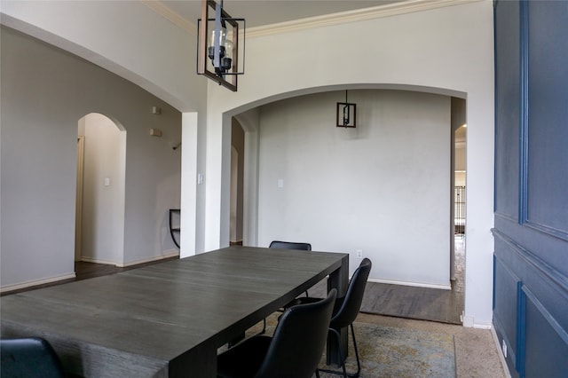 dining space featuring ornamental molding and wood-type flooring