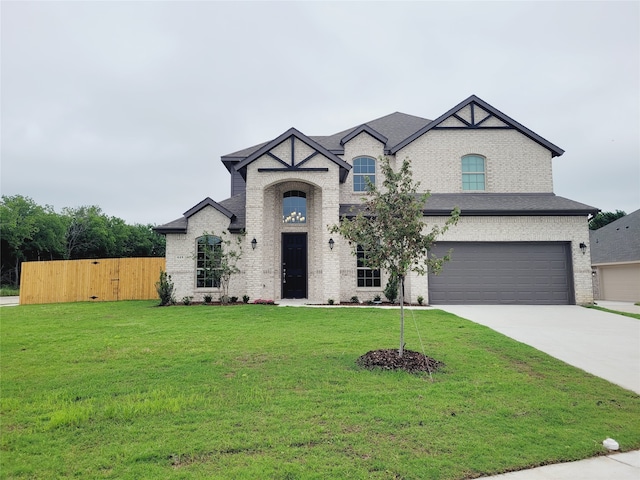 french provincial home featuring a garage and a front lawn