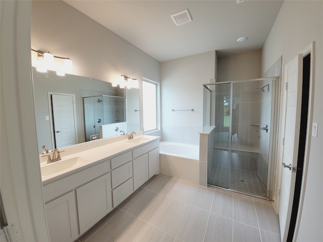 bathroom featuring tile flooring, oversized vanity, shower with separate bathtub, and double sink