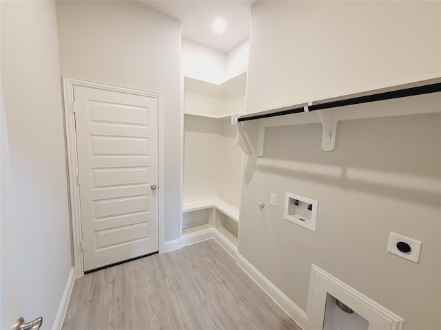 laundry area featuring hookup for an electric dryer, light hardwood / wood-style floors, hookup for a gas dryer, and washer hookup