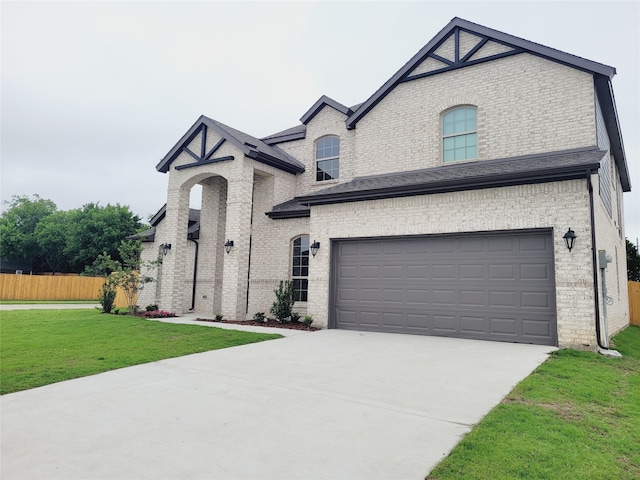 french country home with a front lawn and a garage