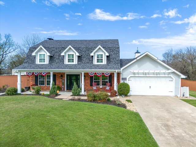 cape cod home featuring a garage, a front lawn, and covered porch