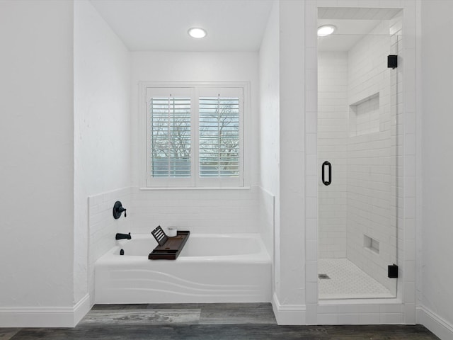 bathroom featuring separate shower and tub and hardwood / wood-style flooring