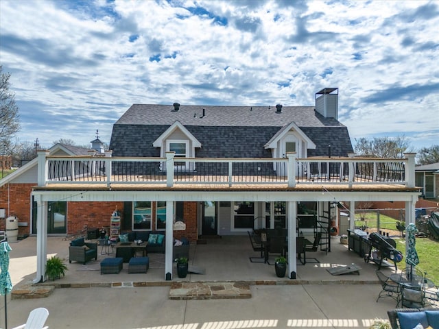 rear view of property featuring a patio, a wooden deck, and an outdoor hangout area