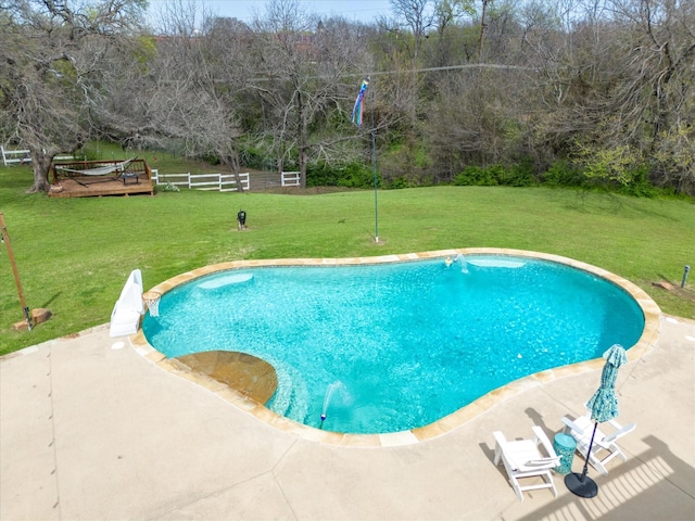 view of swimming pool featuring a lawn and a patio area