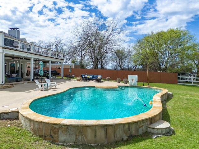 view of swimming pool featuring an outdoor hangout area, pool water feature, a patio area, and a yard