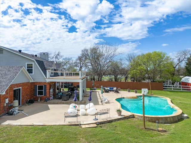 view of pool featuring a patio area, a lawn, and pool water feature