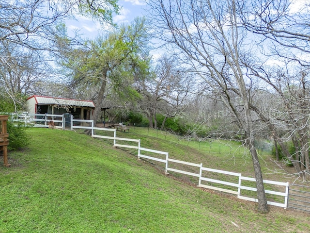 view of yard featuring a rural view and an outbuilding