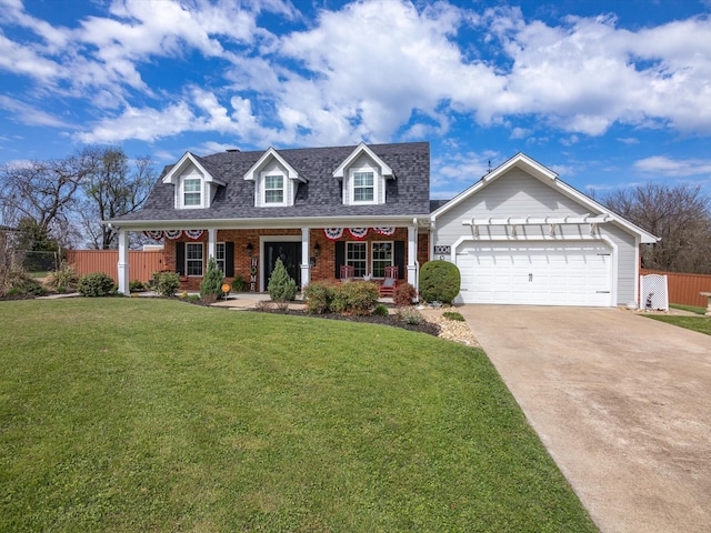 new england style home featuring a garage, covered porch, and a front lawn