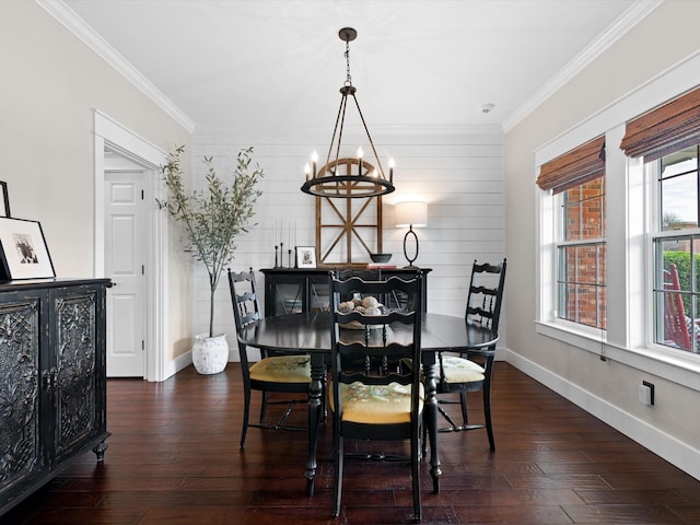 dining space with ornamental molding, dark hardwood / wood-style floors, and an inviting chandelier