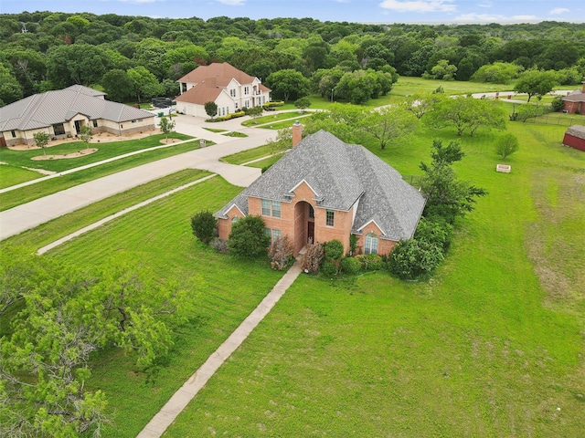 birds eye view of property with a view of trees