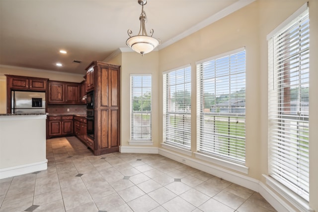 kitchen with decorative light fixtures, black appliances, light tile patterned floors, and crown molding