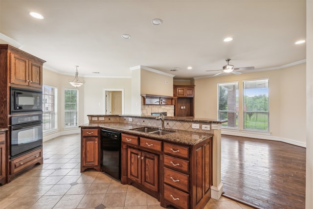 kitchen featuring plenty of natural light, black appliances, ceiling fan, and sink