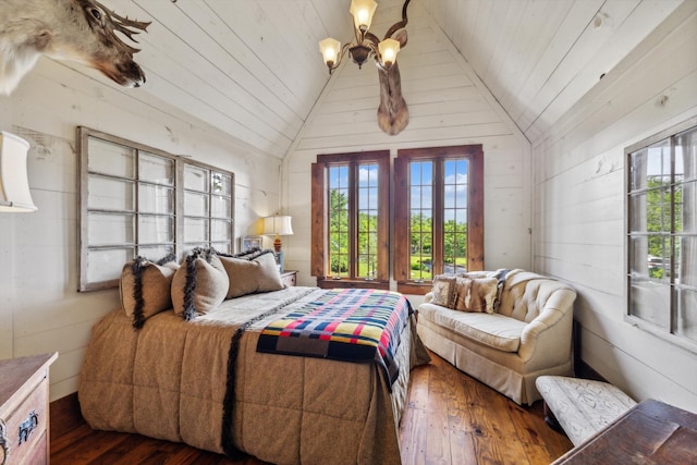 bedroom with dark wood-type flooring, lofted ceiling, an inviting chandelier, wooden walls, and wood ceiling