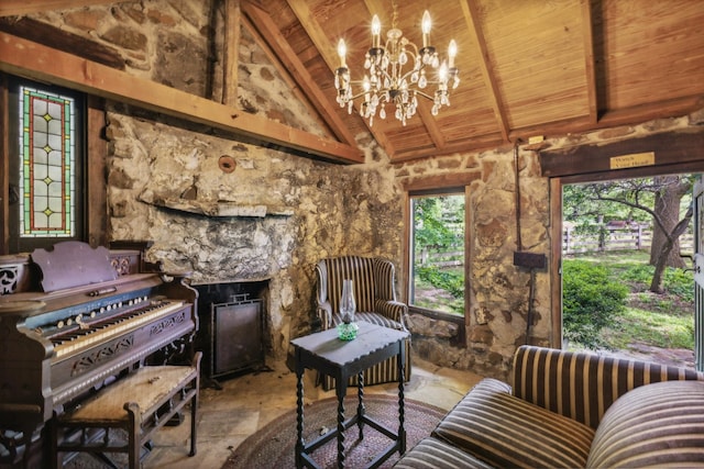 living room featuring vaulted ceiling with beams, a fireplace, an inviting chandelier, and wooden ceiling