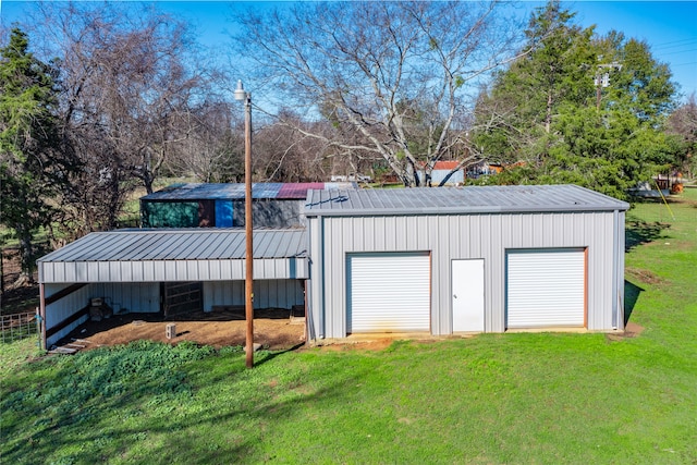 view of outbuilding featuring a garage and a lawn