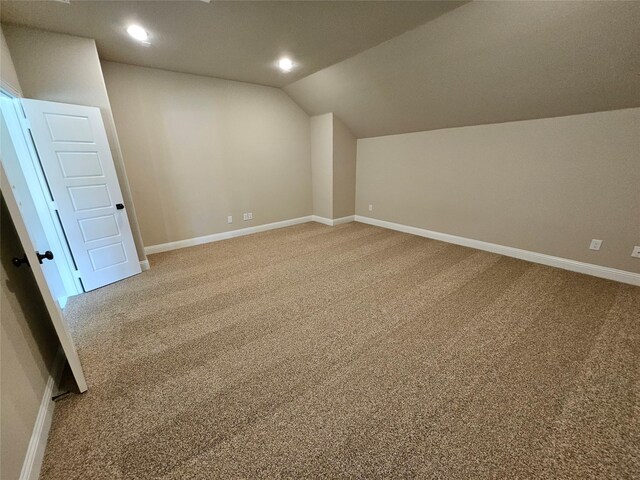 additional living space with lofted ceiling and carpet floors