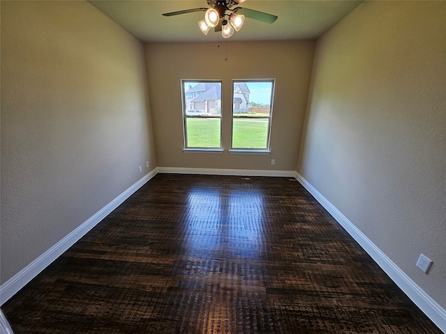 empty room with ceiling fan and dark wood-type flooring