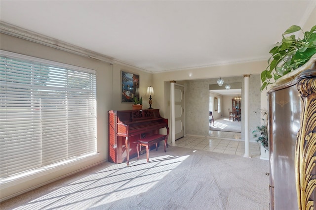 interior space featuring ornamental molding, decorative columns, and light colored carpet