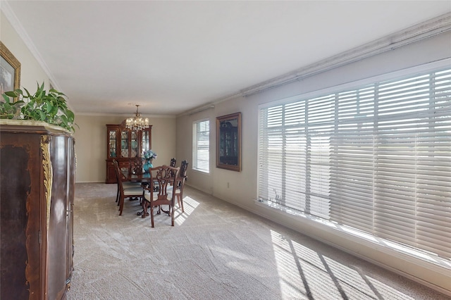 dining room with light carpet, crown molding, and a notable chandelier